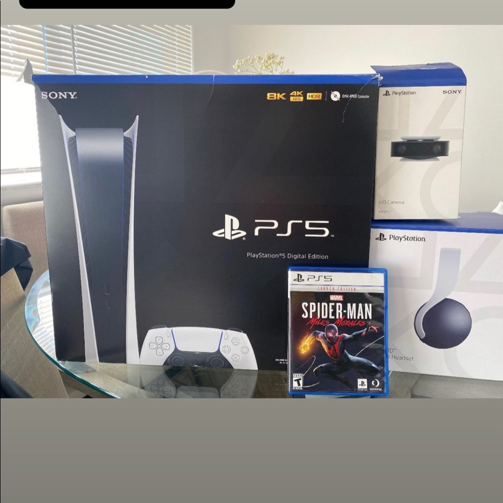 play station 5 disc version comes with head set, a game, and a camera.